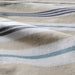 A closeup image of beige/blue duvet cover with a striped pattern   20443515 