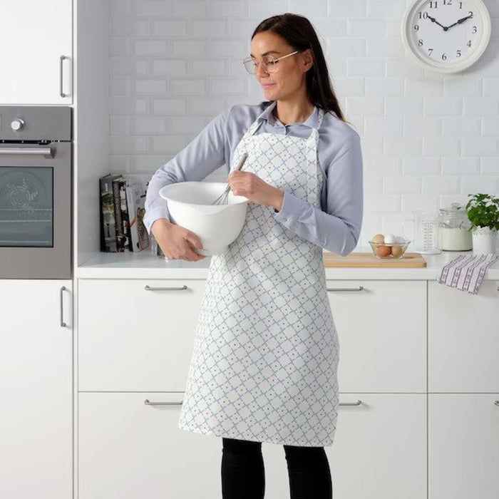 A women wearing an apron, holding a mixing bowl  20493096