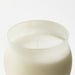 A natural scented candle in a glass jar with a warm and inviting aroma from IKEA