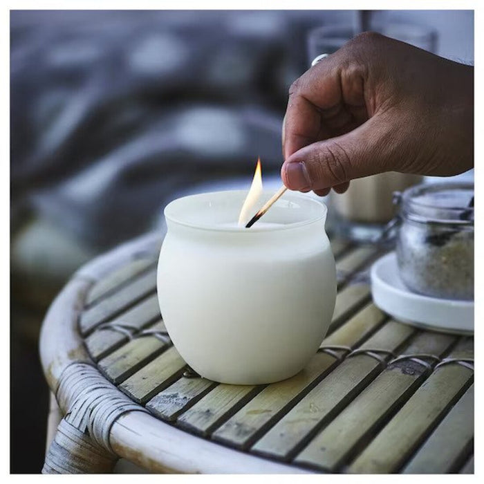 A home fragrance scented candle in a glass jar with a soothing aroma from IKEA