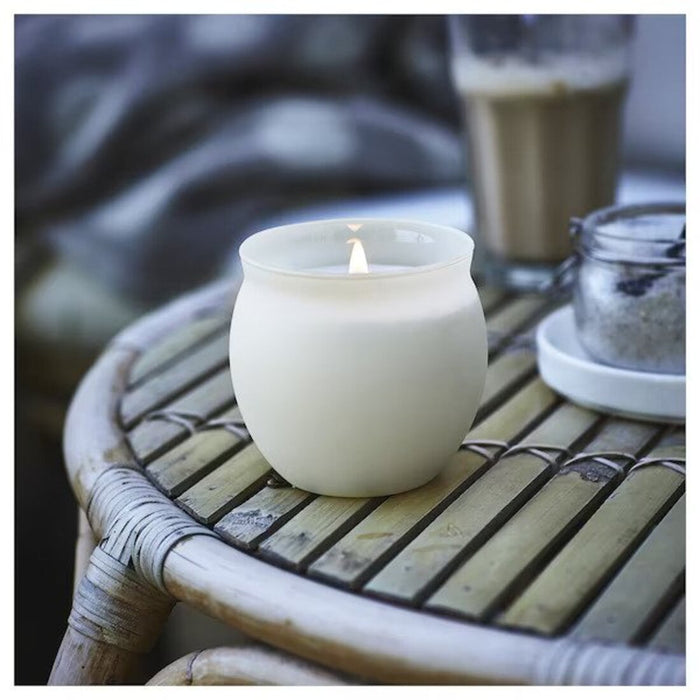A relaxing scented candle in a glass jar with a beautiful design and natural ingredients from IKEA.