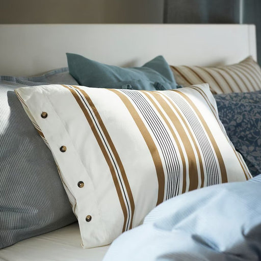 A white-brown cotton pillowcase from IKEA lying on a bed adding a touch of elegance to the bedding  50526439