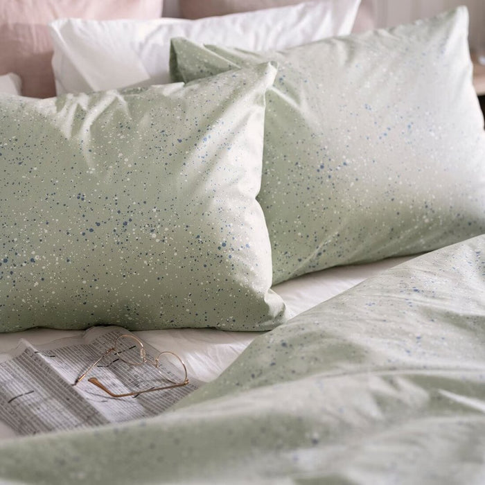 A close-up shot of IKEA's duvet cover in a soft green color with matching pillowcases 90522463