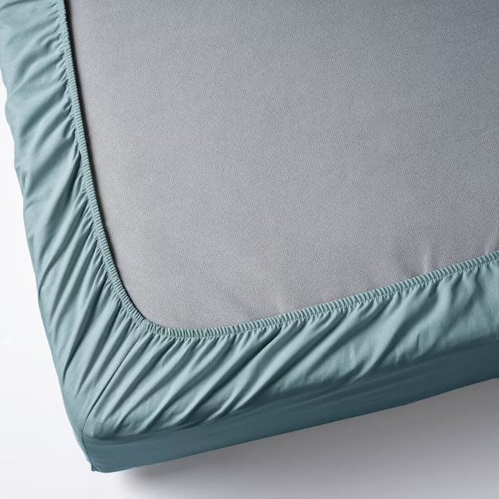 A close-up of an IKEA fitted sheet's elastic edges, showing its stretchiness and durability  00501672