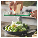 A person's hand using the IKEA Grater with Handle to grate a block of cheese onto a plate, showcasing the comfortable and ergonomic grip of the handle 30160964