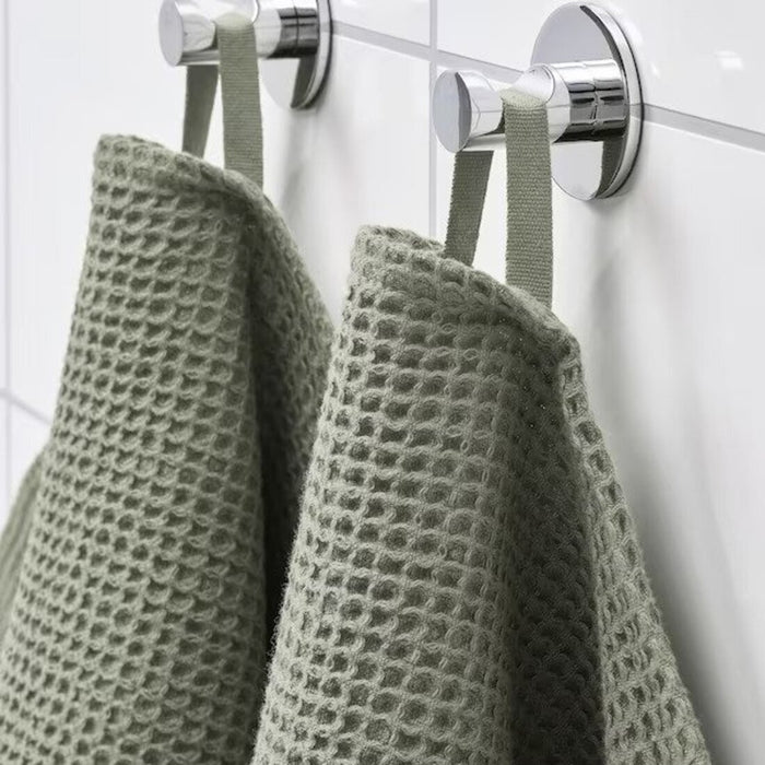 A close-up image of a folded White hand towel with a textured pattern 30512886