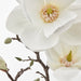 "Artificial white rose bouquet in clear glass vase, ideal for indoor decoration."