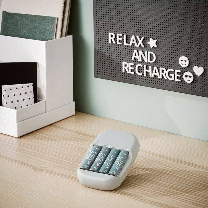 The IKEA Battery Charger on a desk in a home office, providing a convenient charging solution for rechargeable batteries 00506448