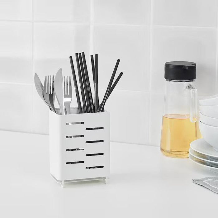 A stainless steel Cutlery Stand from IKEA, shown on a kitchen countertop, with various utensils neatly arranged in the slots.