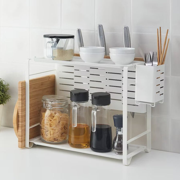 A colorful Cutlery Stand from IKEA, shown with utensils of different colors and sizes in the slots, adding a playful touch to any kitchen.