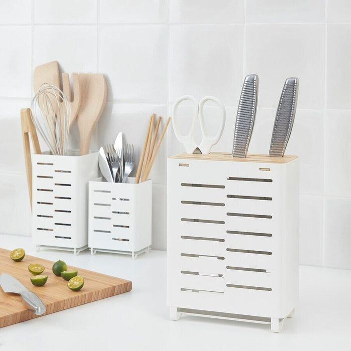 An adjustable Cutlery Stand from IKEA, shown in a kitchen drawer with the compartments expanded and utensils organized.