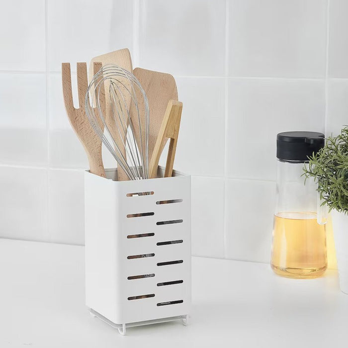 A stainless steel Cutlery Stand from IKEA, shown on a kitchen counter with various utensils neatly organized in its compartments.