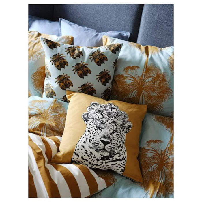 Multiple IKEA cushion covers in different colors and designs on a bed-10542988