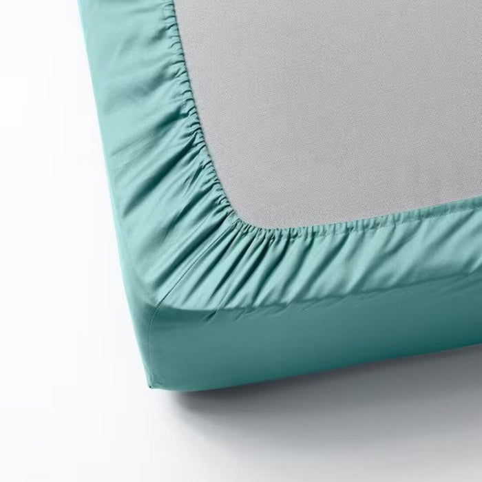 A close-up photo of an IKEA fitted sheet in Grey-Turquoise with elastic edges to fit snugly over a mattress-00486577