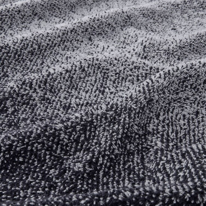 A close-up image of a folded White/Dark Blue hand towel with a textured pattern  20494388