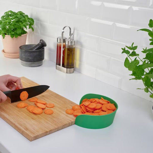 A white IKEA Preparation Bowl on a kitchen countertop with sliced vegetables inside90515165