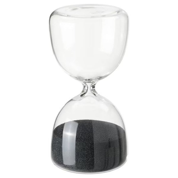 An hourglass with black sand and a modern metal frame, a stylish decorative piece from IKEA.