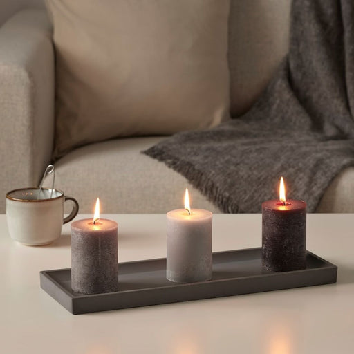 A room with the soft glow of IKEA's scented block candle filling the air with a relaxing fragrance.
