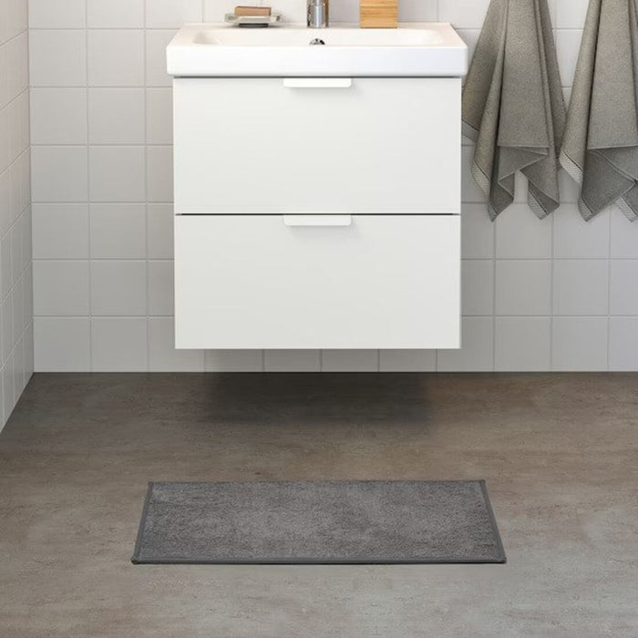  IKEA bath mat placed on a bathroom floor, featuring a soft and absorbent texture and a non-slip bottom for secure footing 70514204