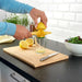 A person's hand using the IKEA Lemon Squeezer to extract fresh juice from a lemon, highlighting its ergonomic grip for comfortable use 70528692