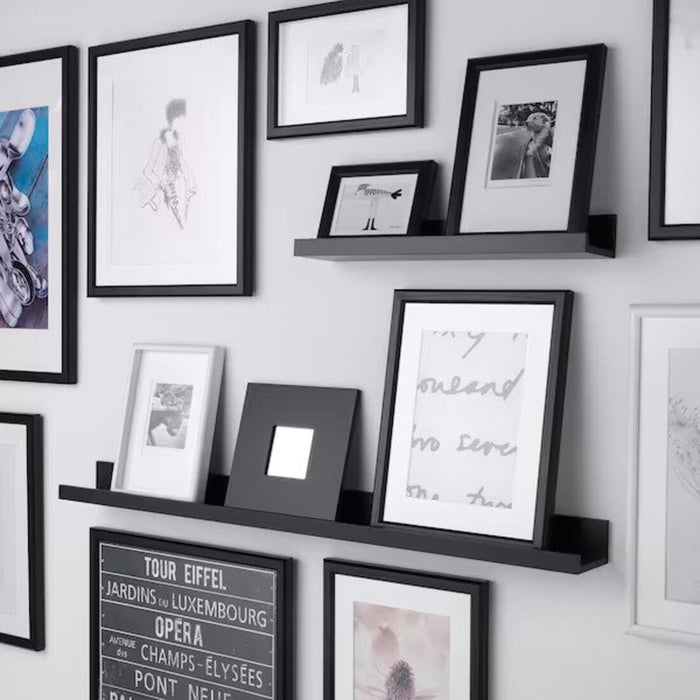 "IKEA Picture Ledge in a living room displaying family photos"