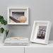 A modern white photo frame with a minimalist design, ideal for showcasing your art or photography 90479214