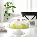 Digital ShoppyA minimalist and elegant white cake stand from IKEA, ideal for displaying cakes and other desserts. 