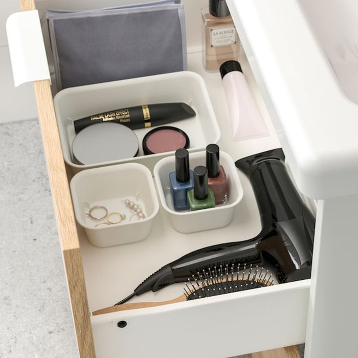 An IKEA organizer with multiple compartments and drawers, perfect for organizing small items like jewelry or office supplies.