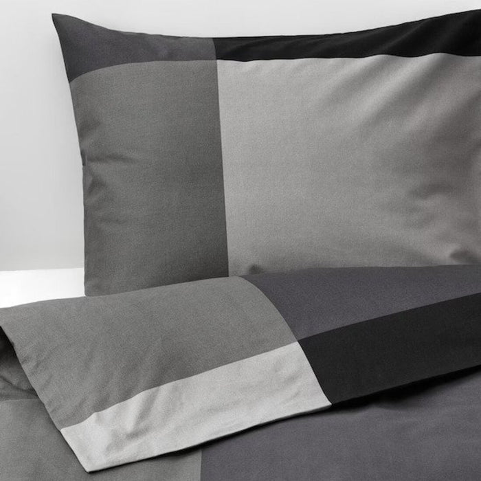 A close-up shot of IKEA's duvet cover in a soft black color with matching pillowcases 60375538
