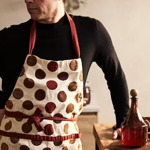 A man wearing a multicolor apron with strips 90534220