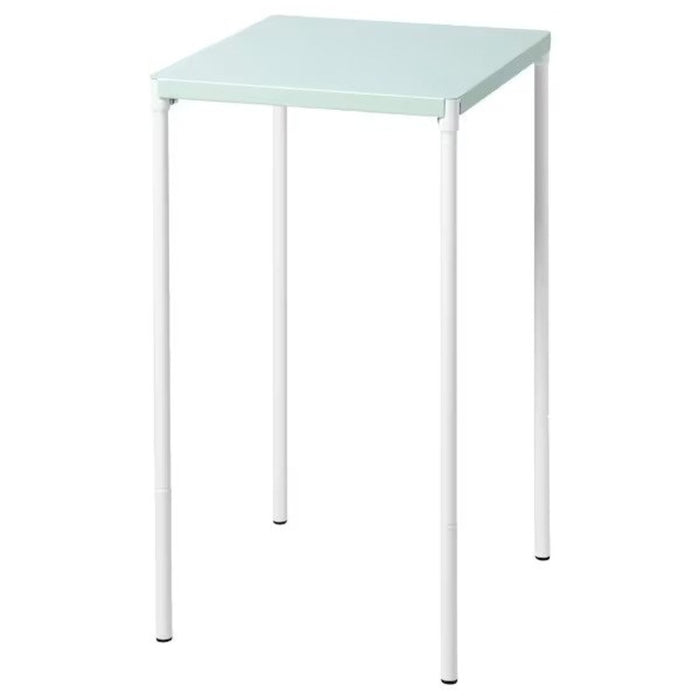 A light green IKEA table with two chairs, perfect for outdoor dining.