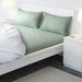 White green cotton flat sheet and 2 pillowcase set from IKEA on a bed  90419084