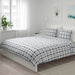 A photo of the bedroom featuring IKEA's duvet cover and pillowcases 30466441 