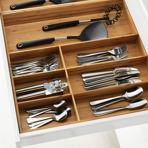 A bamboo cutlery tray with compartments for forks, knives, spoons, and other utensils.
