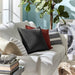 Multiple IKEA cushion covers in different colors and designs on a sofa-5043268
