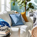 Multiple IKEA cushion covers in different colors and designs on a sofa-10433418