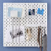 A workspace with an IKEA pegboard hook rack holding a variety of tools and equipment, highlighting the efficiency and convenience of the brand's storage solutions. 60519886