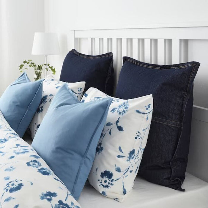 Multiple IKEA cushion covers in different colors and designs on a bed-10433418