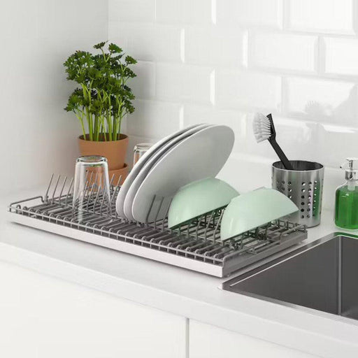 IKEA KUNGSFORS dish drainer on countertop holding green and white bowls plates and glasses