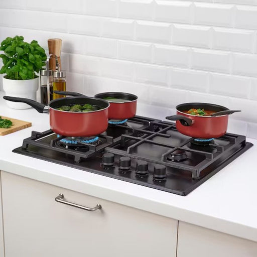 KEA's red saucepan set of 3 in action, showcasing its versatility and durability during cooking 60529786