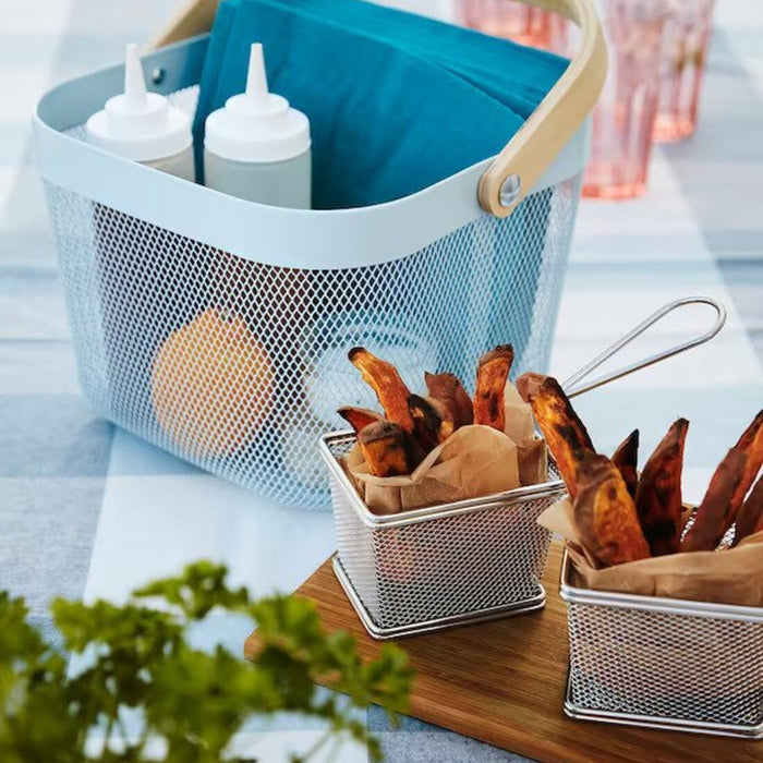 A modern wire basket filled with freshly cooked french fries and dipping sauces 40516860 