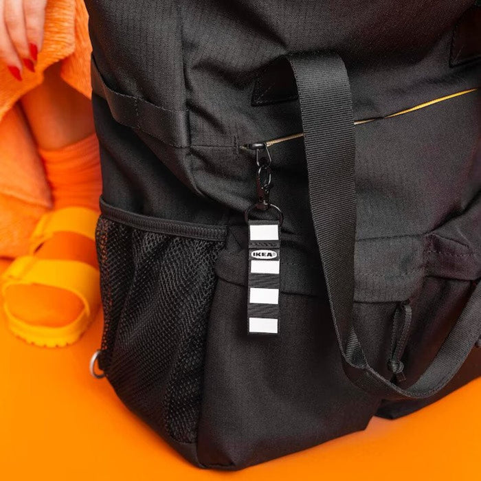 IKEA backpack on a person's back, with a water bottle and camera sticking out of the side pockets.