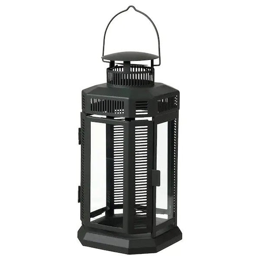 IKEA Lantern for Candle, Indoor/Outdoor - Black metal lantern with clear glass panels, with a candle inside illuminating the surrounding area.