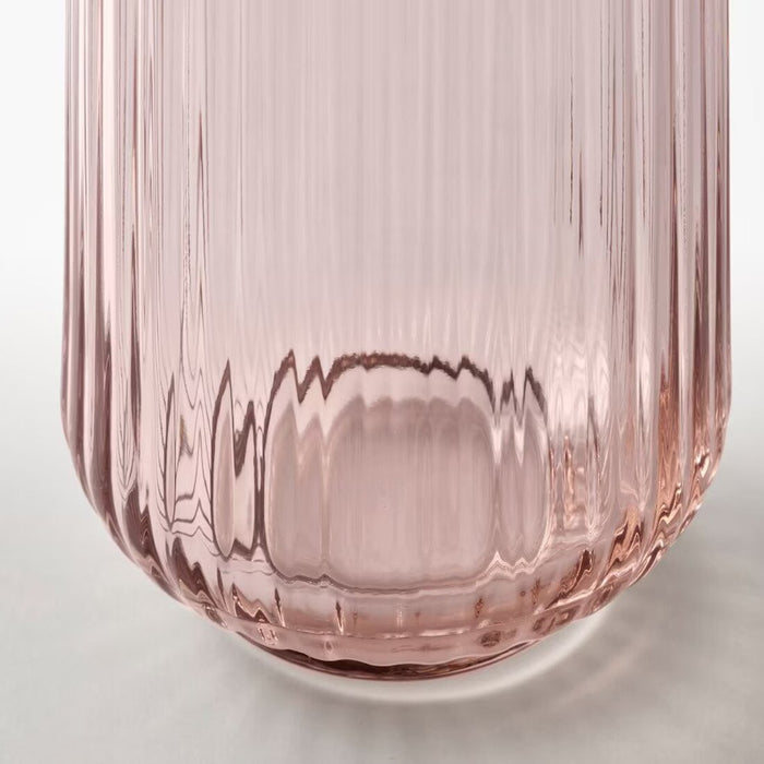 A trendy marble vase with a cylindrical shape and a black-and-pink pattern, adding visual interest to any decor