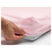 A close-up of a fitted sheet with a textured surface and neatly stitched edges -40320189