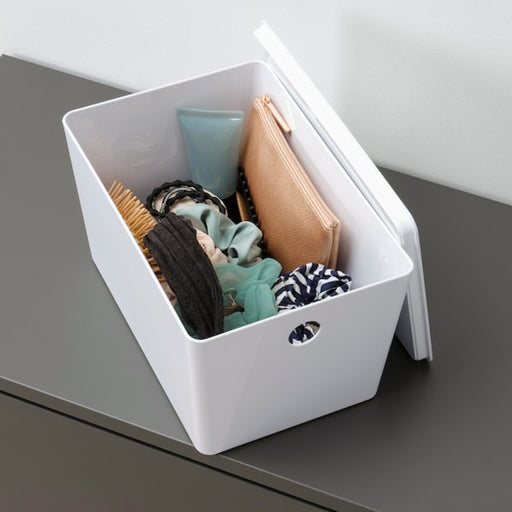 A transparent plastic storage box with a lid from IKEA, with a stackable and modular design that maximizes space and simplifies organization.