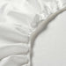 A close-up of an IKEA fitted sheet's elastic edges shows its stretchiness and durability  70347724