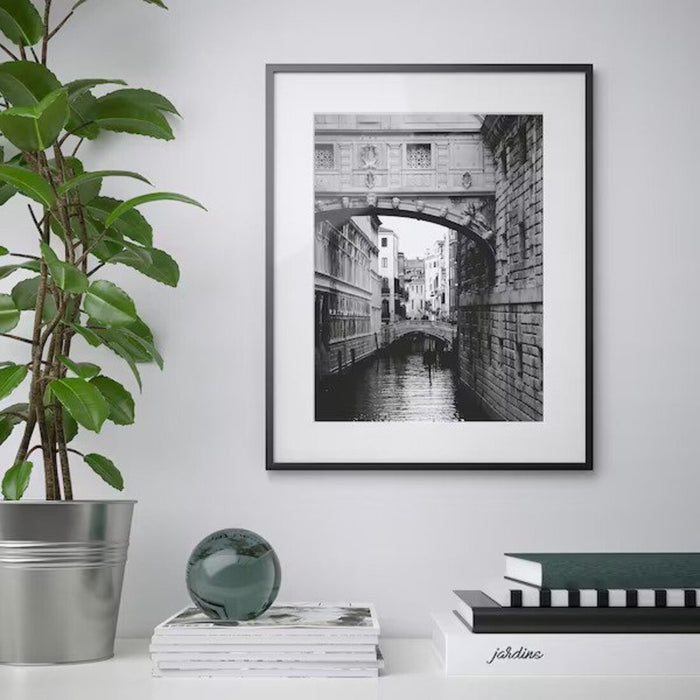 A modern black photo frame with a minimalist design, ideal for showcasing your art or photography 00314307