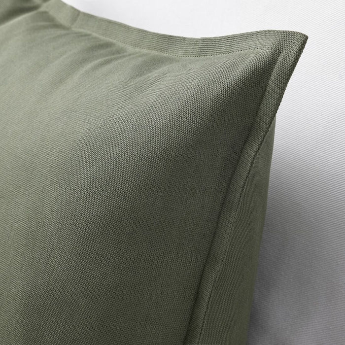 A close-up shot of an Ikea cushion cover in a deep green color40489588