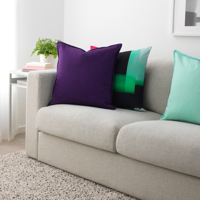 Multiple IKEA cushion covers in different colors and designs on a sofa-80443782